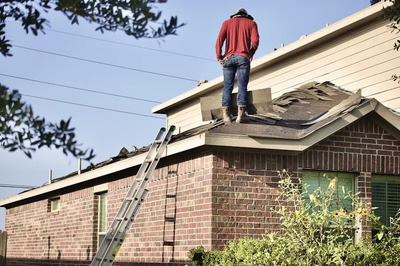 Professional roofer working on a residential roof in Rose Mary Estates
